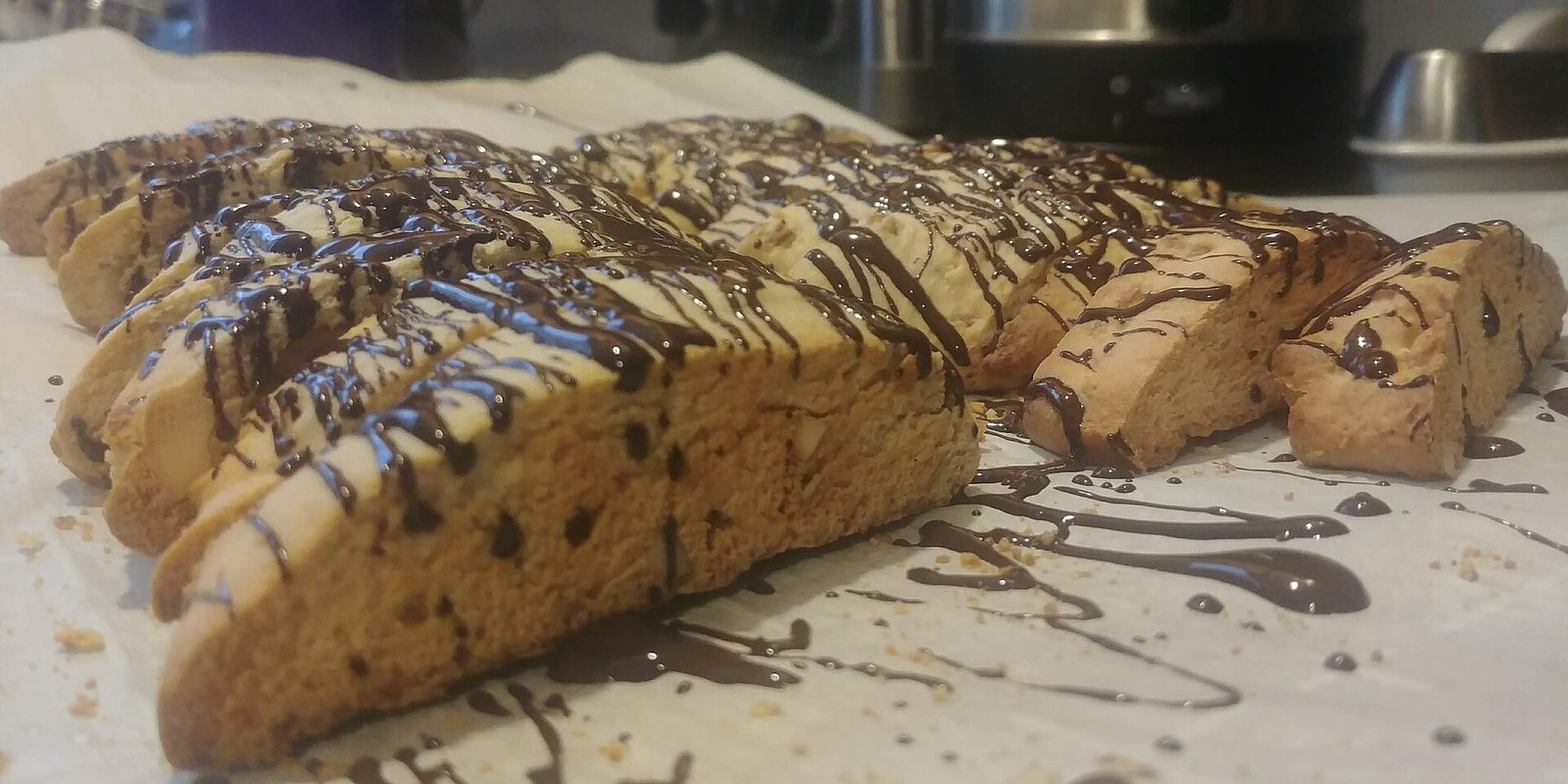 Chocolate-drizzled biscotti cooling on a rack