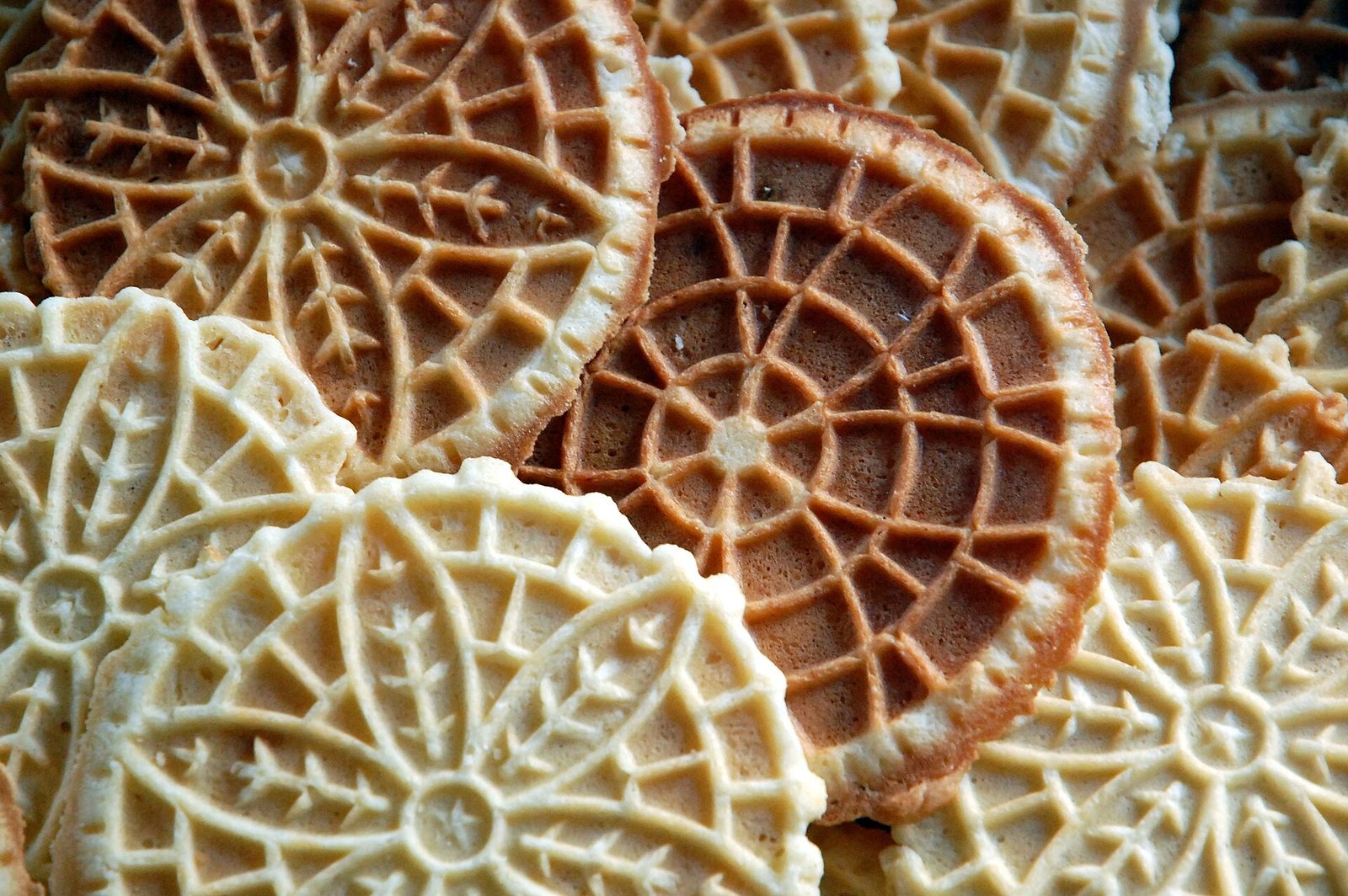 Pizzelle — patterned Italian waffle wafers in a loose stack