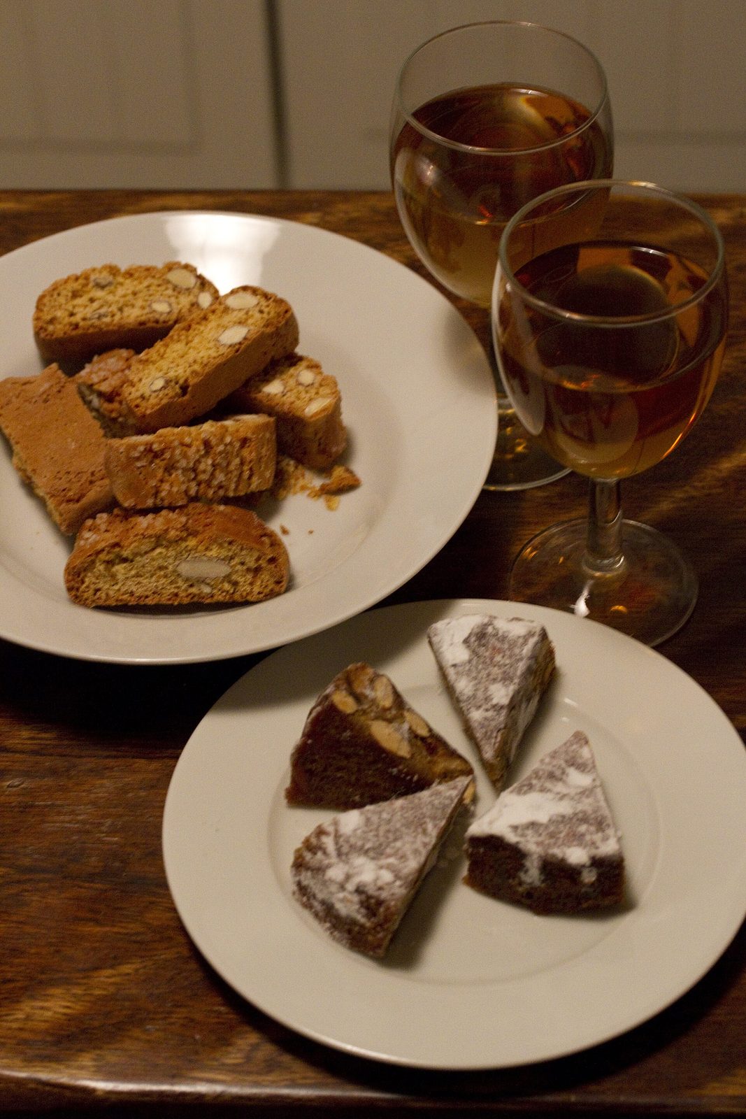 Panforte, biscotti and a bottle of vin santo on a Tuscan table